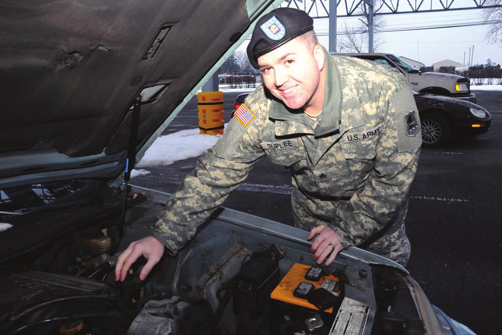 Sgt. Michael Suplee, a network support technician at Joint Force Headquarter, examines the engine of his 1993 Ford Thunderbird.